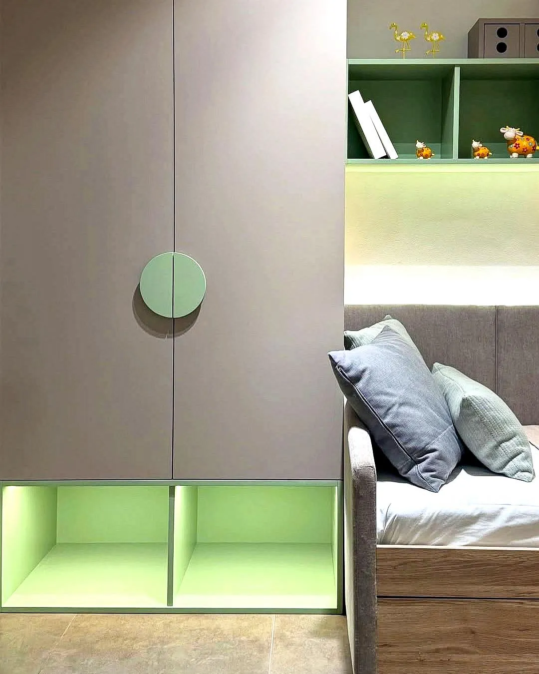 Children's room detail – wardrobe with round handle and open green shelves