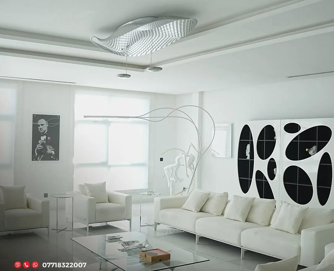 Luxury penthouse by Gambini – living room with white sofas, sculptural wall art and ceiling light