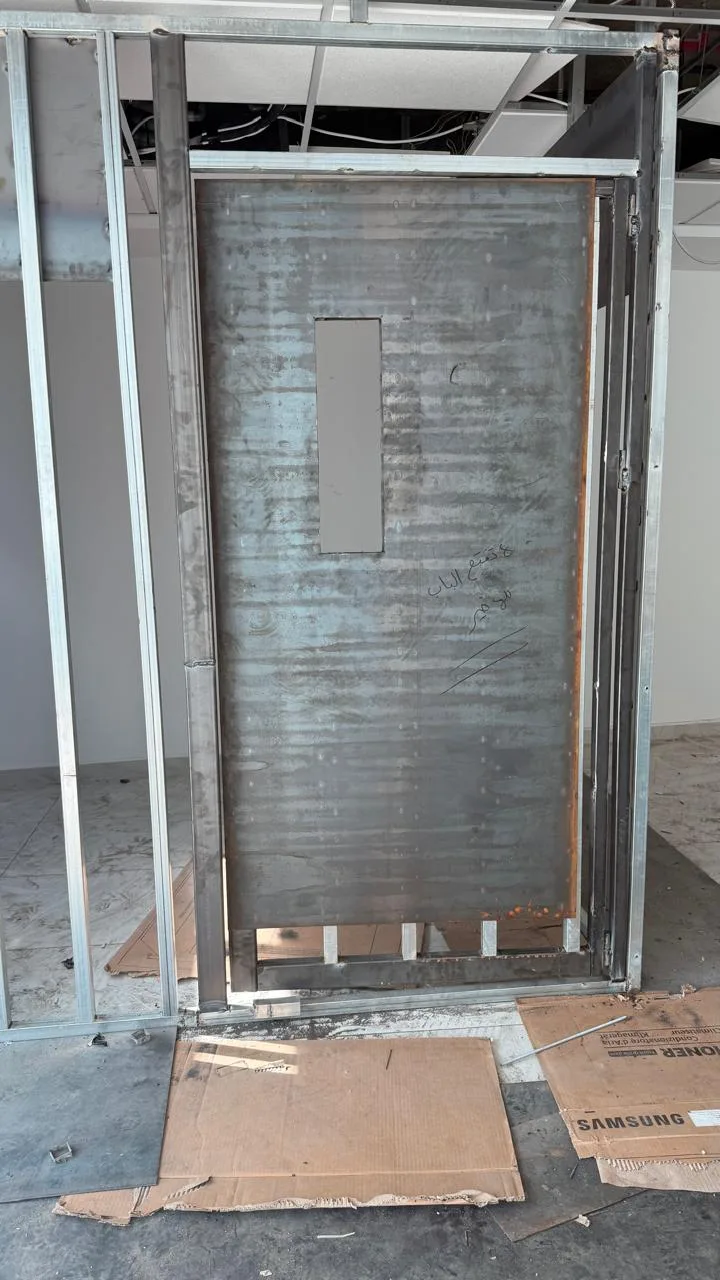 Steel security door leaf with vision panel before finishing